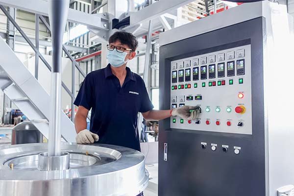 Engineers adjust the film blowing